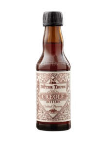 Creole bitters bottle with ornate label.