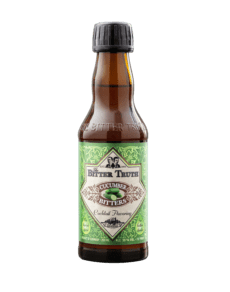 Bottle of aromatic bitters on black background.